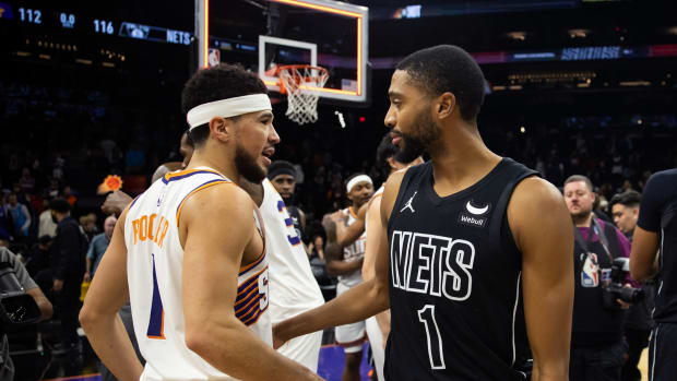 Phoenix Suns guard Devin Booker greets Brooklyn Nets forward Mikal Bridges